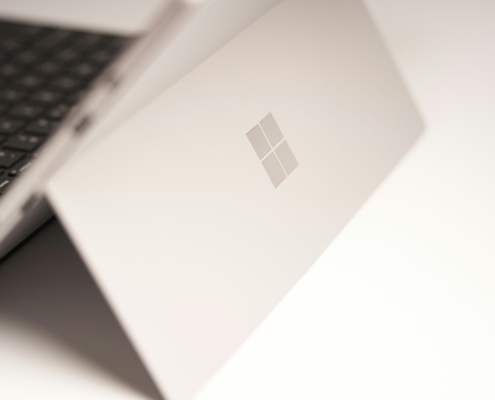 white laptop computer on white table