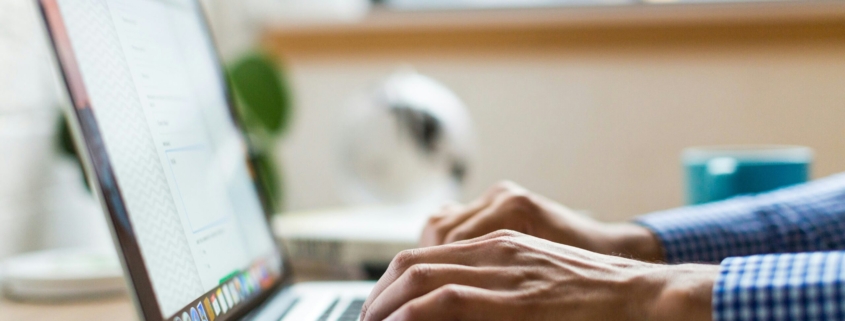 person typing on silver Macbook